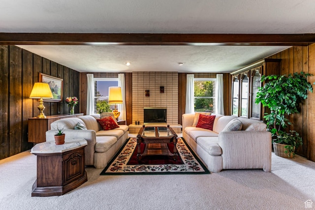 342 E State St, Farmington, UT 84025 - living room with beamed ceiling, wood walls, carpet, a fireplace, and a textured ceiling