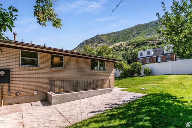 342 E State St, Farmington, UT 84025 - rear view of property with a mountain view, a patio, and brick siding