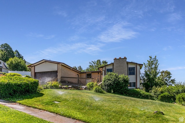 342 E State St, Farmington, UT 84025 - mid-century home with brick siding, a front yard, a chimney, and an attached garage