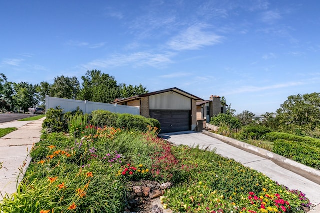 342 E State St, Farmington, UT 84025 - mid-century inspired home featuring concrete driveway, brick siding, and a garage