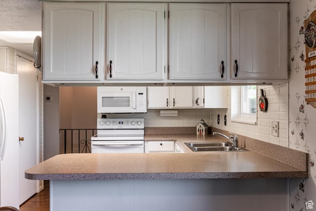 342 E State St, Farmington, UT 84025 - kitchen with white appliances, a peninsula, backsplash, white cabinetry, and wood finished floors