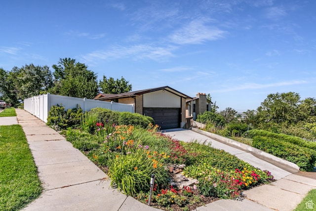 342 E State St, Farmington, UT 84025 - mid-century home with concrete driveway, an attached garage, and brick siding