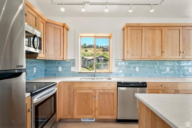 1538 N Mackinaw Way, Garden City, UT 84028 - kitchen with stainless steel appliances, backsplash, light wood finished floors, light brown cabinetry, and rail lighting