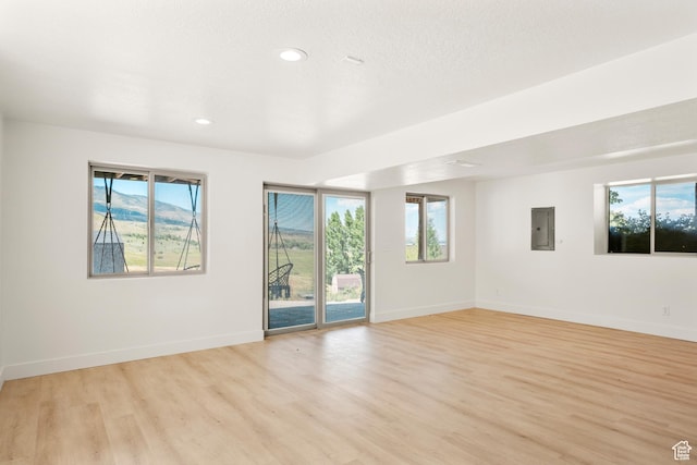1538 N Mackinaw Way, Garden City, UT 84028 - spare room with electric panel, healthy amount of natural light, light wood-style flooring, and recessed lighting