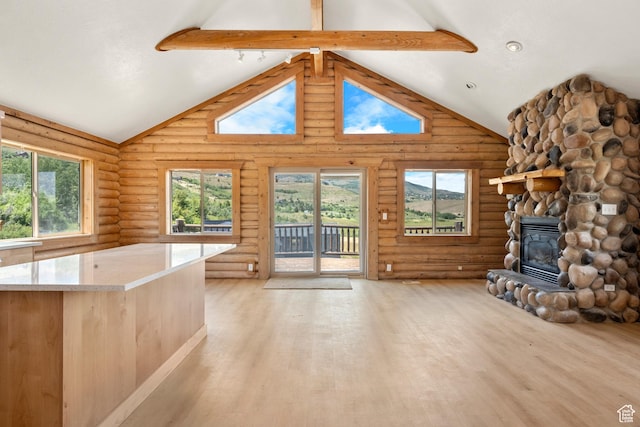 1538 N Mackinaw Way, Garden City, UT 84028 - unfurnished living room featuring rustic walls, light wood-style floors, a fireplace, high vaulted ceiling, and beamed ceiling