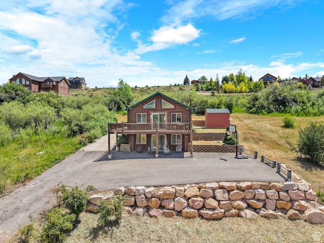 1538 N Mackinaw Way, Garden City, UT 84028 - back of house featuring a patio area, a deck, and a storage unit