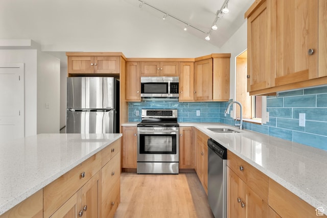 1538 N Mackinaw Way, Garden City, UT 84028 - kitchen featuring stainless steel appliances, lofted ceiling, light stone countertops, light wood-style floors, and backsplash