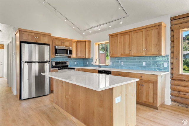 1538 N Mackinaw Way, Garden City, UT 84028 - kitchen with stainless steel appliances, light wood-style floors, a center island, decorative backsplash, and log walls