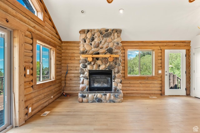 1538 N Mackinaw Way, Garden City, UT 84028 - unfurnished living room with vaulted ceiling, a fireplace, wood finished floors, and rustic walls
