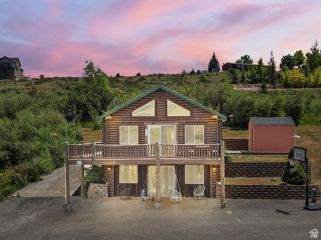1538 N Mackinaw Way, Garden City, UT 84028 - log-style house with a deck, log exterior, and a shed