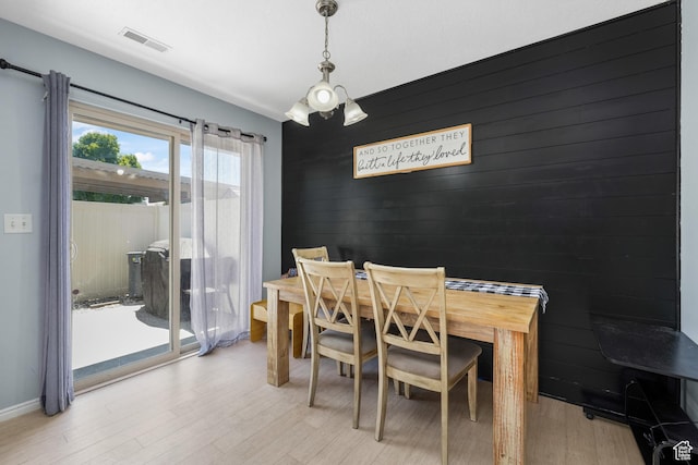 1244 E 800 N Unit 43, Spanish Fork, UT 84660 - dining space with light wood-style flooring, a chandelier, and an accent wall