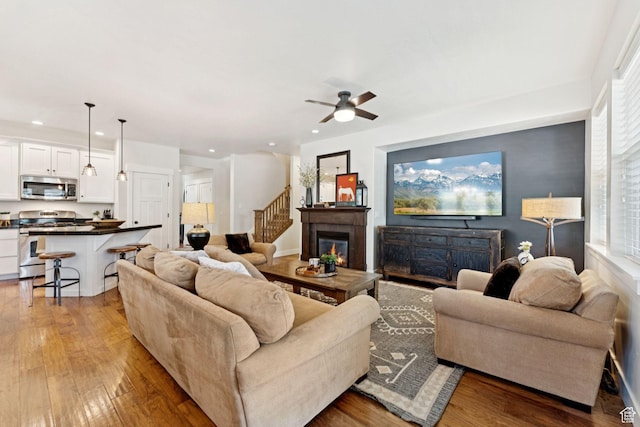 693 S Silver Leaf Dr W, Mapleton, UT 84664 - living area with recessed lighting, light wood-type flooring, ceiling fan, and a glass covered fireplace