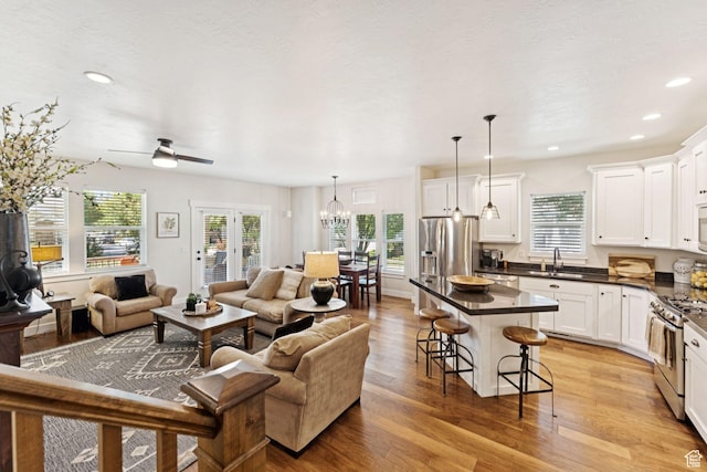 693 S Silver Leaf Dr W, Mapleton, UT 84664 - living room with light wood-style floors, recessed lighting, a chandelier, and ceiling fan