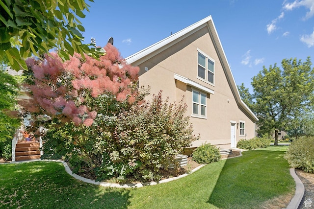 693 S Silver Leaf Dr W, Mapleton, UT 84664 - view of home's exterior with stucco siding and a yard