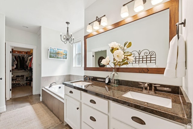 693 S Silver Leaf Dr W, Mapleton, UT 84664 - full bathroom with double vanity, a chandelier, a garden tub, tile patterned flooring, and a walk in closet