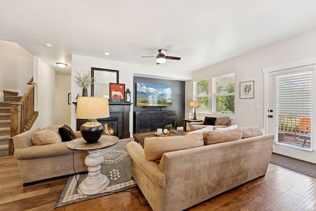 693 S Silver Leaf Dr W, Mapleton, UT 84664 - living room featuring wood finished floors, stairs, a glass covered fireplace, and ceiling fan