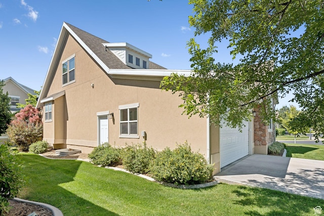693 S Silver Leaf Dr W, Mapleton, UT 84664 - view of home's exterior featuring a yard, driveway, an attached garage, and stucco siding