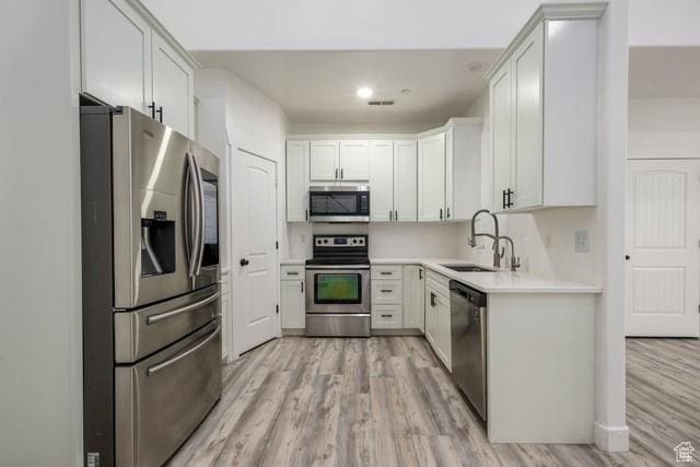 63 E Bridle Villa Dr, Draper, UT 84020 - kitchen featuring stainless steel appliances, light wood-style flooring, light countertops, white cabinetry, and recessed lighting