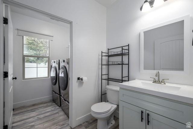 63 E Bridle Villa Dr, Draper, UT 84020 - bathroom featuring washer and clothes dryer, vanity, and wood finished floors