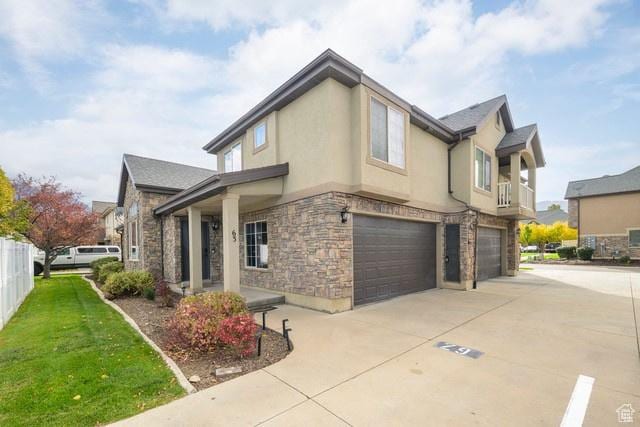 63 E Bridle Villa Dr, Draper, UT 84020 - view of side of home featuring stone siding, a garage, driveway, and stucco siding