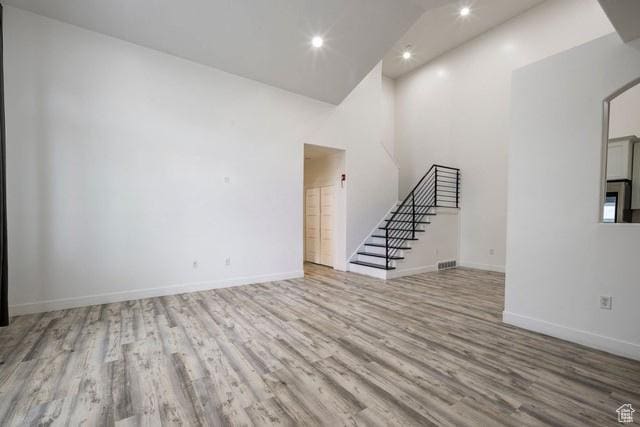 63 E Bridle Villa Dr, Draper, UT 84020 - unfurnished living room featuring wood finished floors, stairs, recessed lighting, and high vaulted ceiling