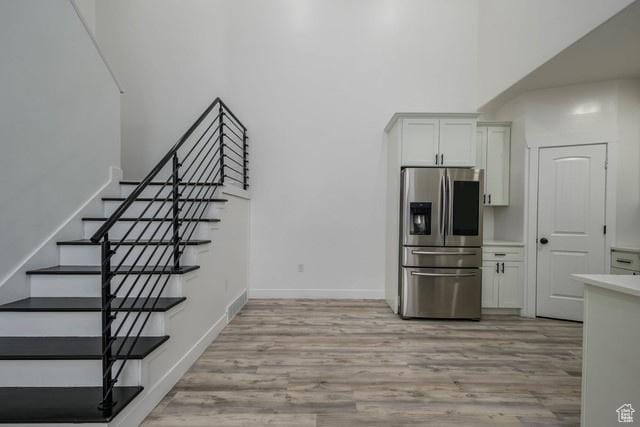 63 E Bridle Villa Dr, Draper, UT 84020 - stairway featuring a towering ceiling and wood finished floors