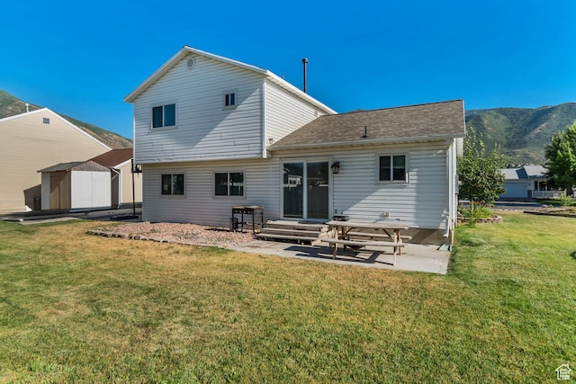 3149 E 1610 S, Spanish Fork, UT 84660 - back of property with a patio area, a storage unit, a lawn, a mountain view, and entry steps