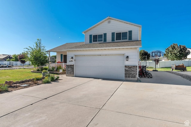 3149 E 1610 S, Spanish Fork, UT 84660 - view of front of property with concrete driveway, an attached garage, roof with shingles, and stone siding