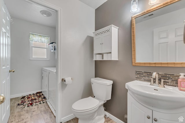 3149 E 1610 S, Spanish Fork, UT 84660 - bathroom with vanity, wood finished floors, and decorative backsplash