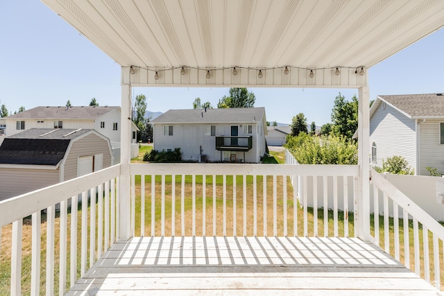 431 S Oakwood Dr W, Logan, UT 84321 - wooden deck featuring a storage unit, a yard, and a residential view