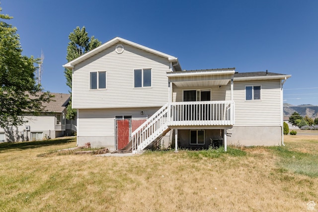 431 S Oakwood Dr W, Logan, UT 84321 - rear view of house featuring stairs, a lawn, and a wooden deck