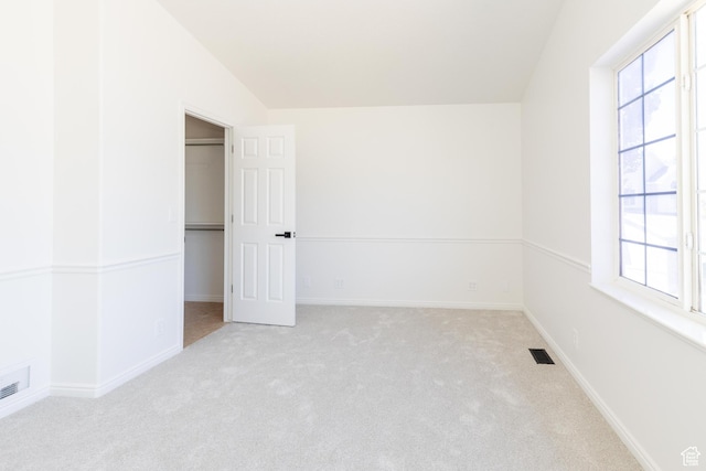 431 S Oakwood Dr W, Logan, UT 84321 - unfurnished bedroom featuring carpet, a spacious closet, and lofted ceiling