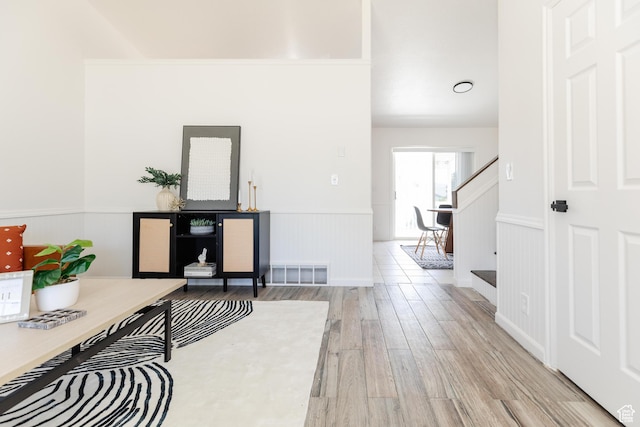 431 S Oakwood Dr W, Logan, UT 84321 - corridor featuring light wood-style floors, wainscoting, and stairway