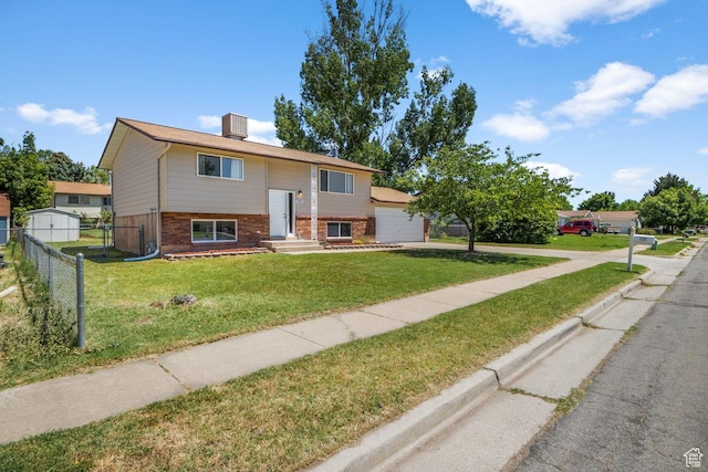 5062 S 2875 W, Roy, UT 84067 - bi-level home featuring brick siding, concrete driveway, and an attached garage