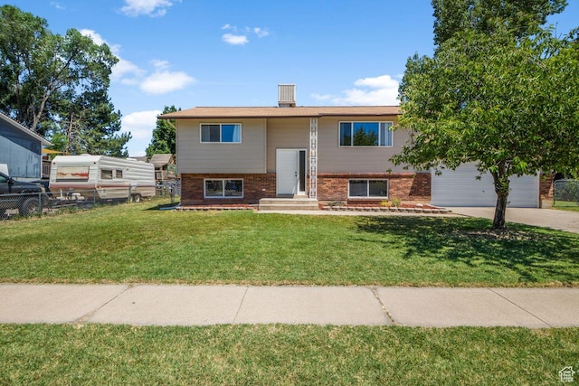 5062 S 2875 W, Roy, UT 84067 - split foyer home with brick siding, driveway, and a garage