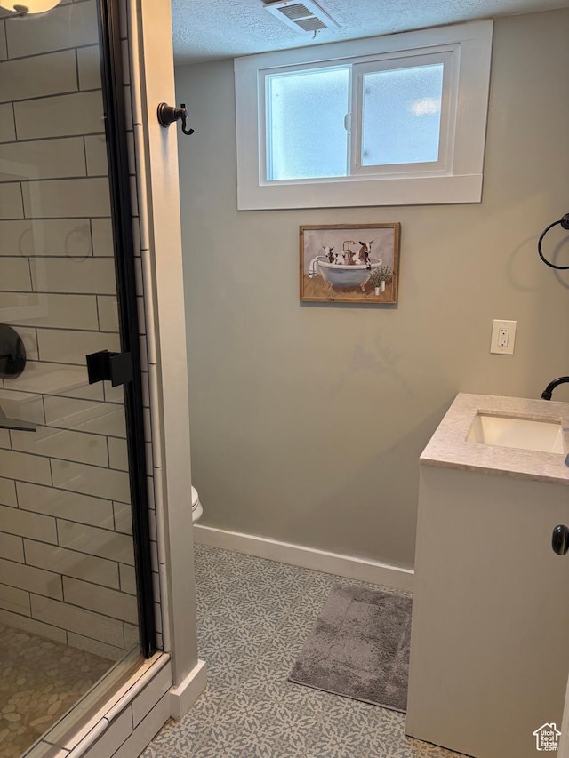 2044 Madison Ave, Ogden, UT 84401 - full bathroom featuring a stall shower, vanity, tile patterned floors, and a textured ceiling