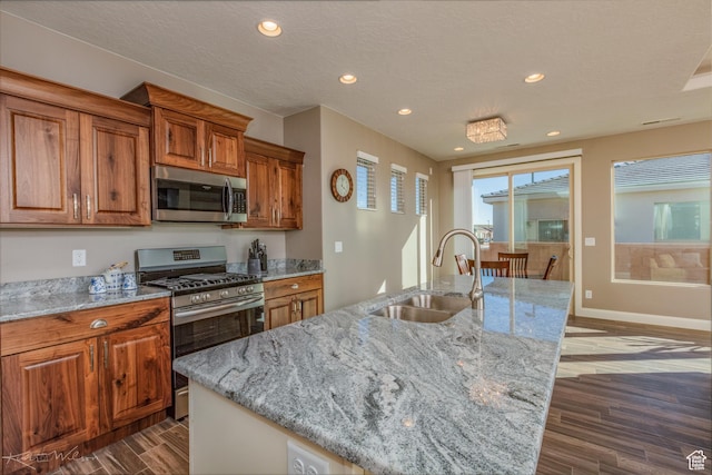 3429 W 175 N, Hurricane, UT 84737 - kitchen with appliances with stainless steel finishes, brown cabinets, recessed lighting, dark wood-type flooring, and light stone countertops