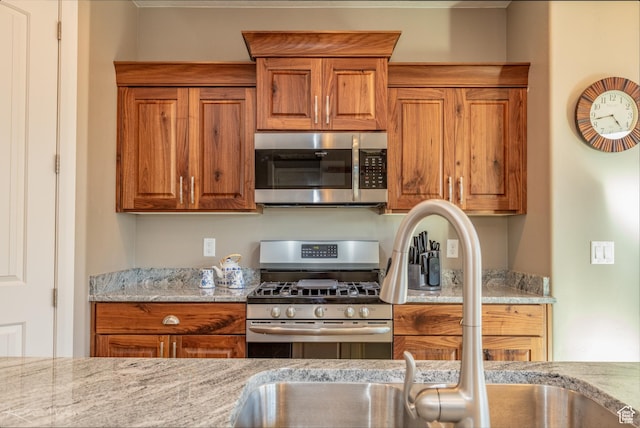 3429 W 175 N, Hurricane, UT 84737 - kitchen featuring stainless steel appliances, brown cabinets, and light stone counters