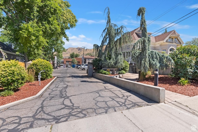 650 N 300 W Unit 229, Salt Lake City, UT 84103 - view of road with a gate, a gated entry, a mountain view, and curbs