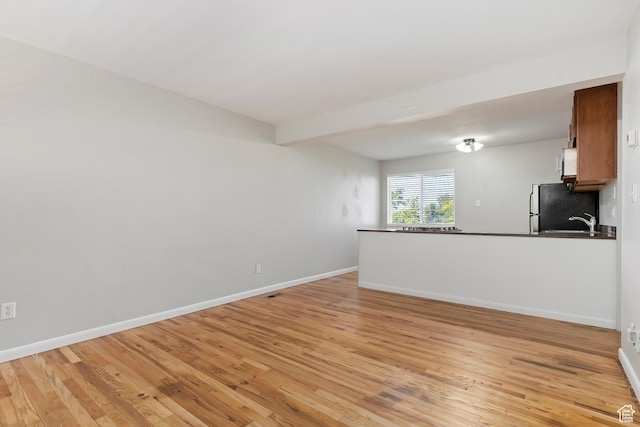 650 N 300 W Unit 229, Salt Lake City, UT 84103 - unfurnished living room with light wood-type flooring and baseboards