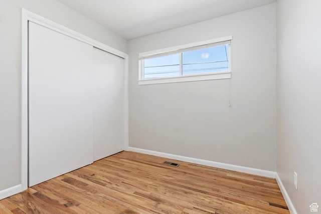 650 N 300 W Unit 229, Salt Lake City, UT 84103 - unfurnished bedroom with light wood-style floors and a closet