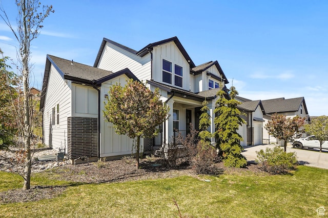 15008 S Springtime Rd, Draper Ut Cnty, UT 84020 - view of property exterior with board and batten siding, a lawn, driveway, covered porch, and a garage