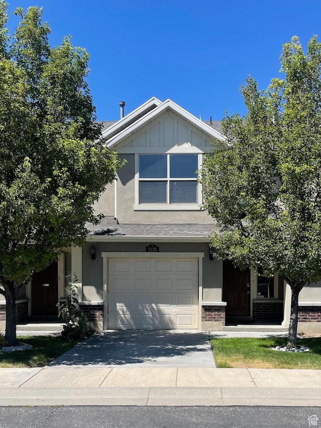 2126 W Fernside St, West Haven, UT 84401 - view of front of house featuring brick siding, a garage, concrete driveway, and stucco siding