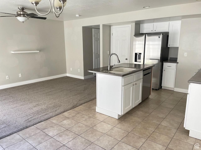 2126 W Fernside St, West Haven, UT 84401 - kitchen featuring dark countertops, appliances with stainless steel finishes, light colored carpet, and ceiling fan