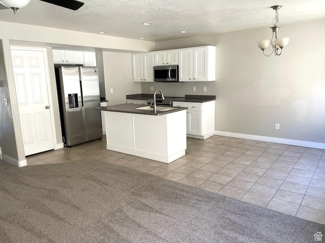 2126 W Fernside St, West Haven, UT 84401 - kitchen with stainless steel appliances, light tile patterned flooring, dark countertops, a textured ceiling, and white cabinetry