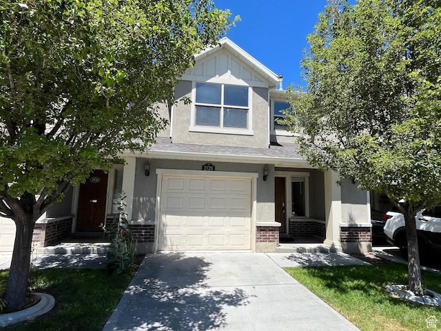 2126 W Fernside St, West Haven, UT 84401 - traditional-style house featuring brick siding, driveway, an attached garage, stucco siding, and a porch