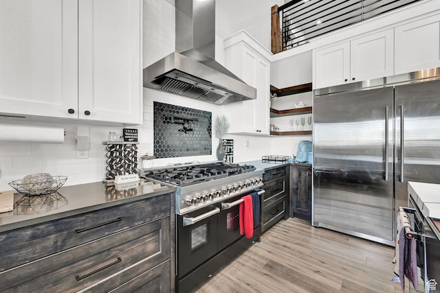 2673 S 4950 W, Taylor, UT 84401 - kitchen with wall chimney exhaust hood, high quality appliances, white cabinets, and decorative backsplash