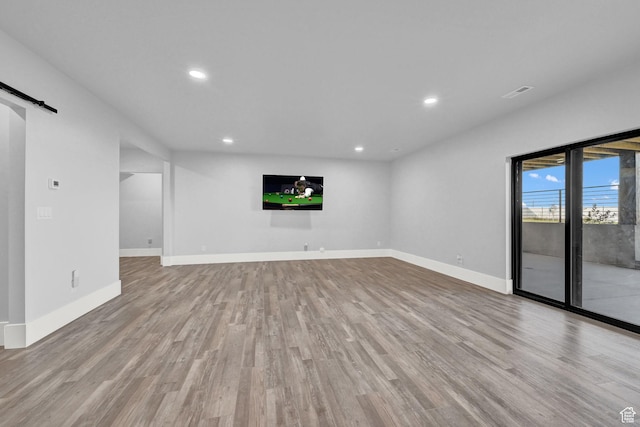 2673 S 4950 W, Taylor, UT 84401 - unfurnished living room featuring wood finished floors, recessed lighting, and a barn door