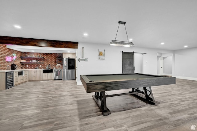 2673 S 4950 W, Taylor, UT 84401 - recreation room with beverage cooler, a barn door, light wood finished floors, recessed lighting, and wet bar