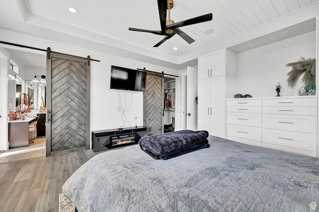 2673 S 4950 W, Taylor, UT 84401 - bedroom with a barn door, light wood-style flooring, ceiling fan, and recessed lighting